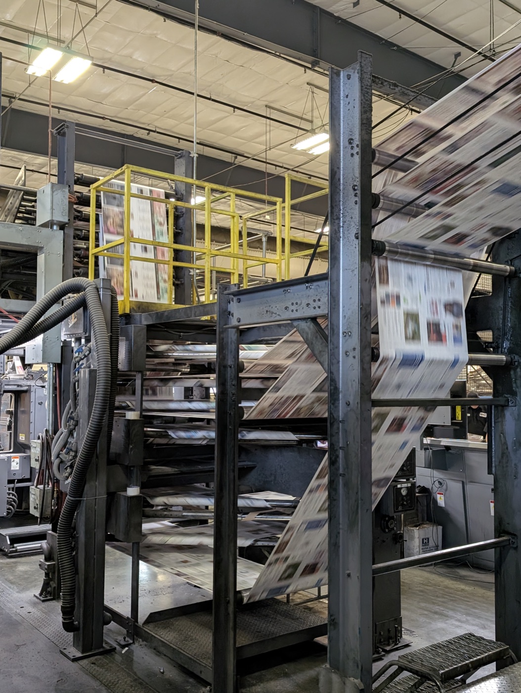 Newspapers running through the heatset folder at CIP